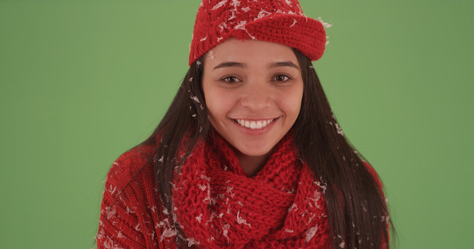 Close-up of millennial latina in red winter clothing on green screen