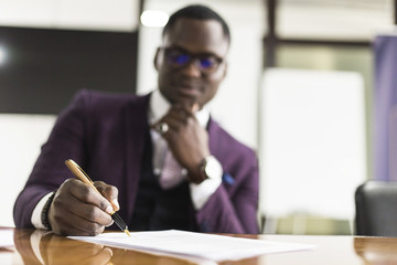 African american man signing contract, black man hand putting signature on official document,...
