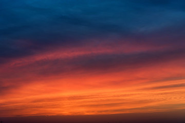 Dramatic sunset sky with blue and red clouds