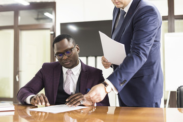 African american man signing contract, black man hand putting signature on official document, biracial clients customers couple make purchase or sign prenuptial agreement concept