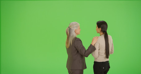 Corporate boss advises young employee on green screen