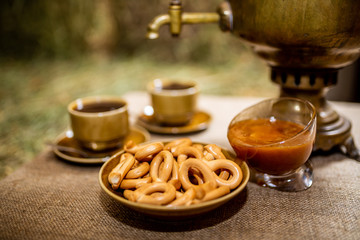 Russian samovar with honey and  ceramic cup of tea. Russian  Black Tea from Samovar