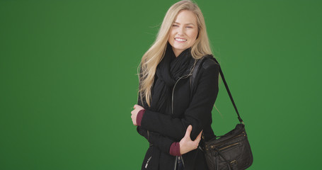 Young white woman smiles at the camera on green screen