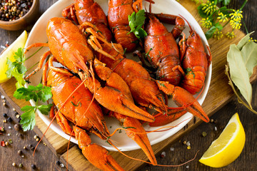 Boiled crawfish, lemon and parsley on a wooden table. Appetizer protein, the concept of healthy eating.