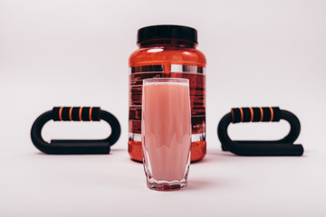 Can of protein and ready-made sports drink in glass