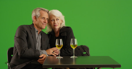 Elderly couple out on a date at restaurant together on green screen