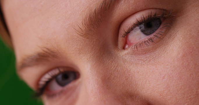 Close up of Caucasian woman's blue eyes looking at camera on green screen