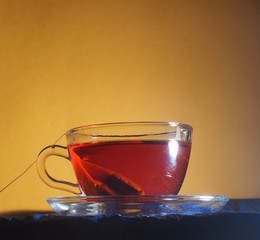 Brewing tea in a transparent glass Cup with a tea bag.