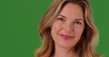 Close up of happy middle aged Caucasian woman on green screen
