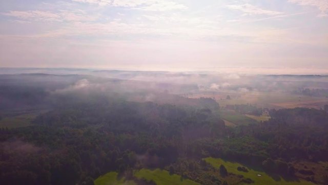 4j AERIAL: Flight over misty fields and forest at early autumn sunrise. Polish landscape. 3840x2160, 24fps.
