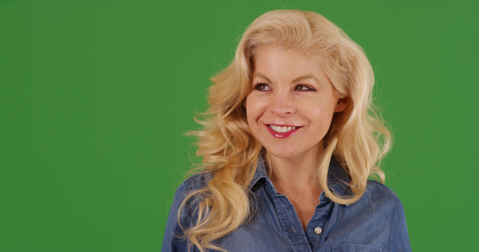 Close up of attractive blonde woman looking around smiling on green screen - Powered by Adobe