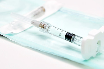 A new syringe filled with a medical product and lying on a table