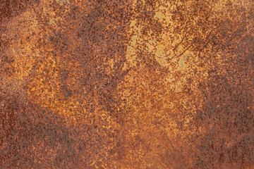 Rusty yellow-red textured metal surface. The texture of the metal sheet is prone to oxidation and corrosion. Textured Background in Grunge Style