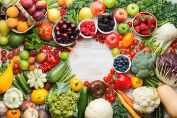 Healthy summer fruits vegetables berries arranged in a circle frame, cherries peaches strawberries cabbage broccoli cauliflower squash tomatoes carrots beetroot, copy space, top view, selective focus