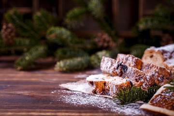  Christmas or New Year pastries Holidays Concept Dresdnen Stollen Traditional German Cake Wooden Background Gift Fruit Cake Holiday , European festive dessert Decoration Copy space for Text