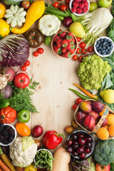 Fresh farm fruits vegetables berries, cherries apricots strawberries cabbage broccoli cauliflower squash tomatoes carrots spring onions beans beetroot, pepper, copy space, top view, vertical