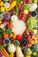 Fresh farm fruits vegetables berries, cherries apricots strawberries cabbage broccoli cauliflower squash tomatoes carrots spring onions beans beetroot, pepper, copy space, top view, vertical