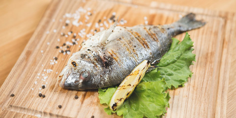 Grilled fish with vegetables on the table