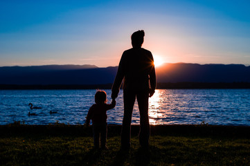 Mother and son silhouete at sunset. 