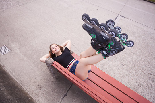 Crazy woman on bench wearing roller skates