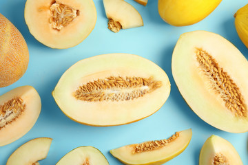 Flat lay composition with melons on color background