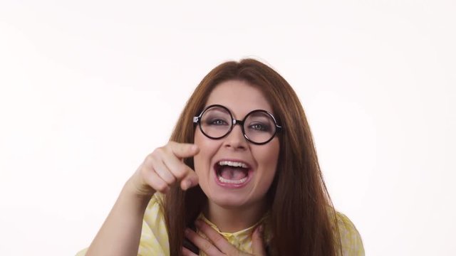 Woman laughing, looking at camera pointing you, showing loser gesture sign with L fingers on forehead. 4K ProRes HQ codec