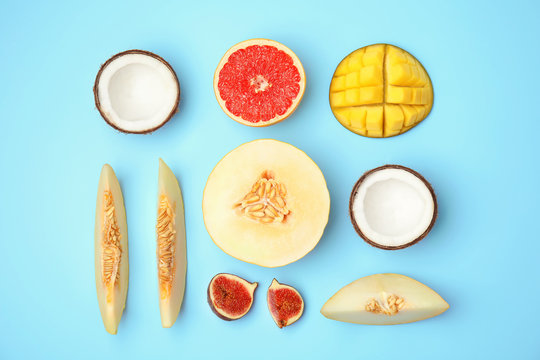 Flat lay composition with melon and other fruits on color background