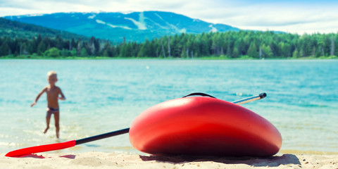 Water sports , active lifestyle.	Boy swimming on paddle board.