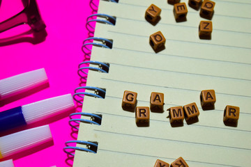 Grammar. Motivation message written on wooden blocks. Cross processed image