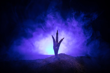 Fototapeta na wymiar Halloween concept, zombie hand rising out from the ground or zombie hand coming out of his grave