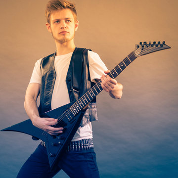 Young man playing electric guitar