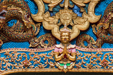 Thai style cement carving art on temple wall  in Wat Chai Mongkon - Buddhist Temple , Chiang Mai Thailand