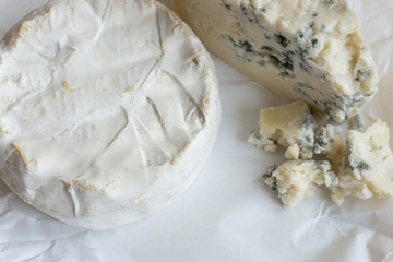 cheeses on a wooden background
