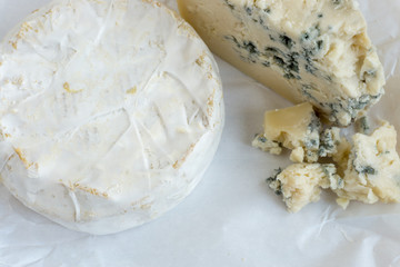 cheeses on a wooden background