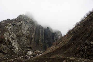 Panorama of the foggy winter landscape in the mountains with snow and rocks, Azerbaijan, Lahic, Big Caucasus