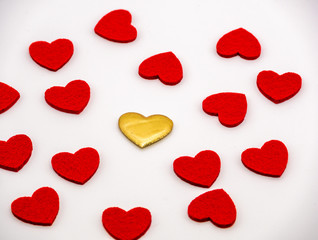 Golden heart in the middle of red hearts