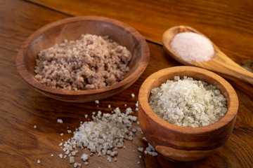 Different Salts Displayed in Wooden Bowls and on Wooden Table