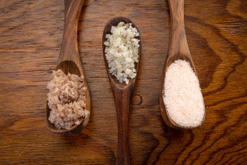 Different Salts Displayed in Wooden Bowls and on Wooden Table