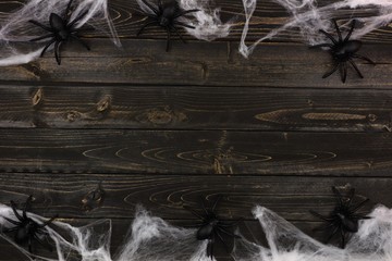 Halloween spider web double border against a dark wooden background with copy space