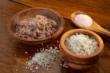 Different Salts Displayed in Wooden Bowls and on Wooden Table