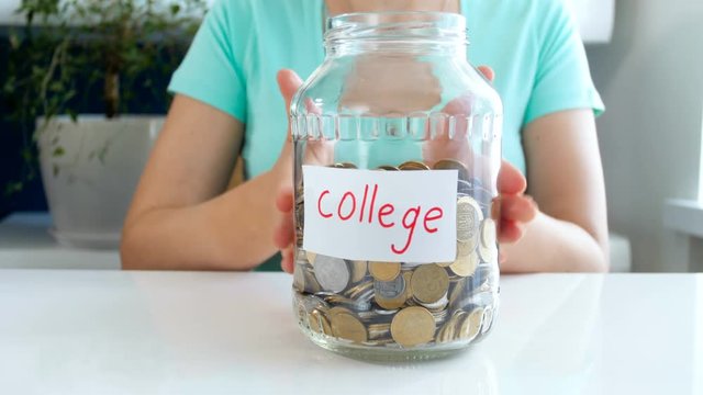 Closeup 4k conceptual footage of young woman saving money for education in college