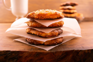 Cookies with cottage cheese, baked until golden brown, shifted thin paper, wooden background.