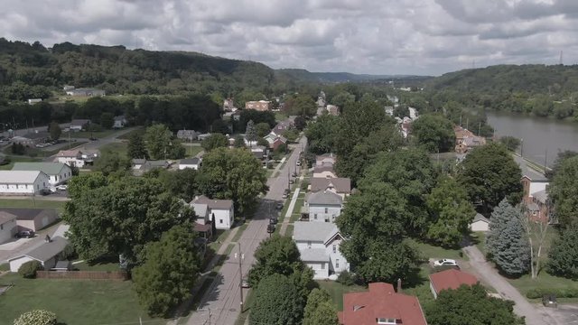 A summer aerial establishing shot of the residential district of a small Pennsylvania town. Pittsburgh suburbs.
