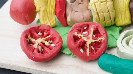 Tomato, onion, chili, pork, pineapple, corn and lettuce mold clay sculpture create of BBQ art food