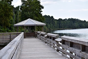 wooden boardwalk leads to gazebo with bench seating North Carolina USA