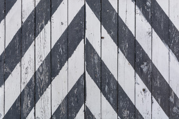 Wooden door to the warehouse, painted in oblique black stripes
