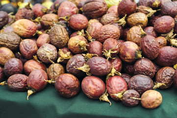 View of red passion fruits stacked in a farmers market stall