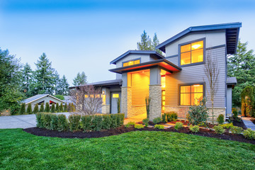 Grey luxury modern two story tall house exterior with stone columns