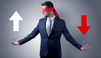 Covered eye businessman choosing between two directions 