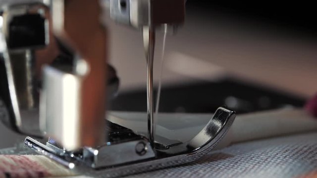 Close up of sewing machine showing process. Item of clothing, vintage style. sewing process in the phase of overstitching. Tailoring Process. Fashion concept. Macro view